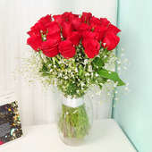 24 Red Roses in Glass Vase on Table